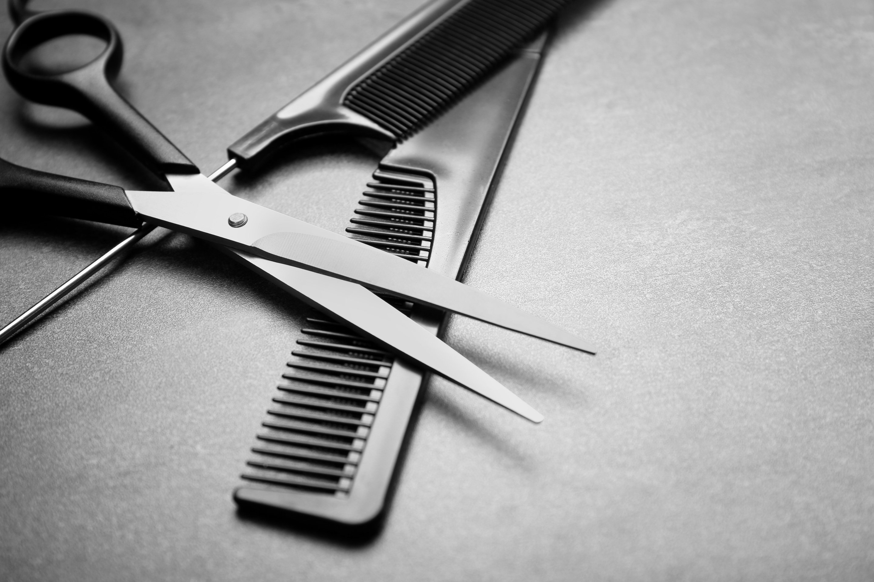 Barber Tools with Two Combs and Scissors on Gray Background